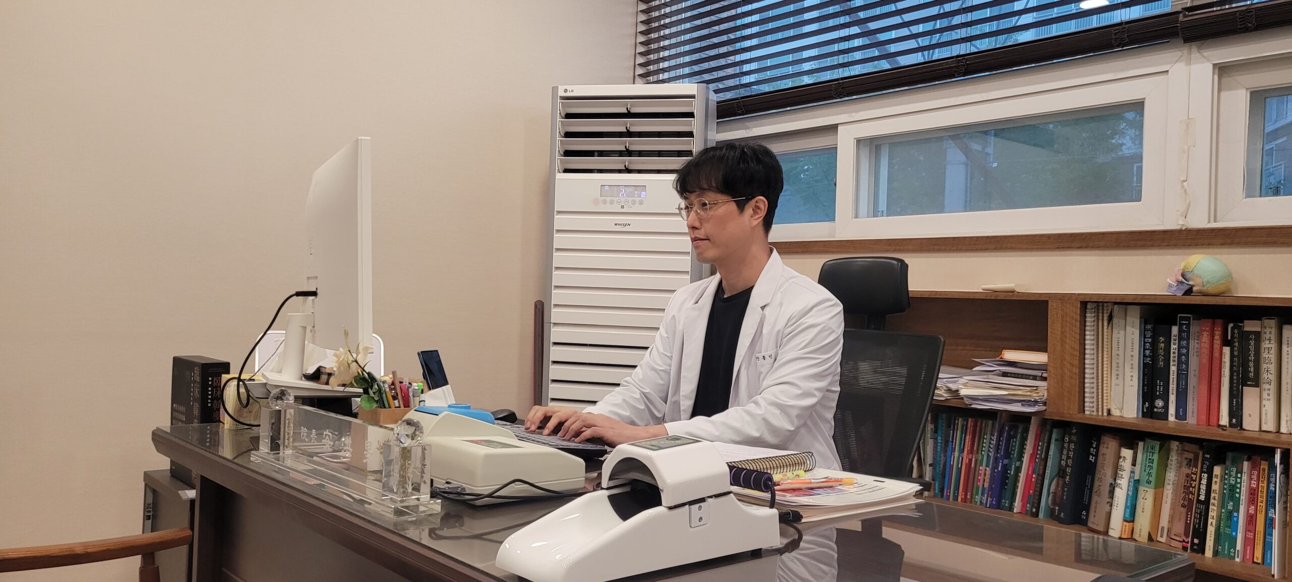 대흥한의원 진료실에서 진료 기록을 살피는 안홍민 원장